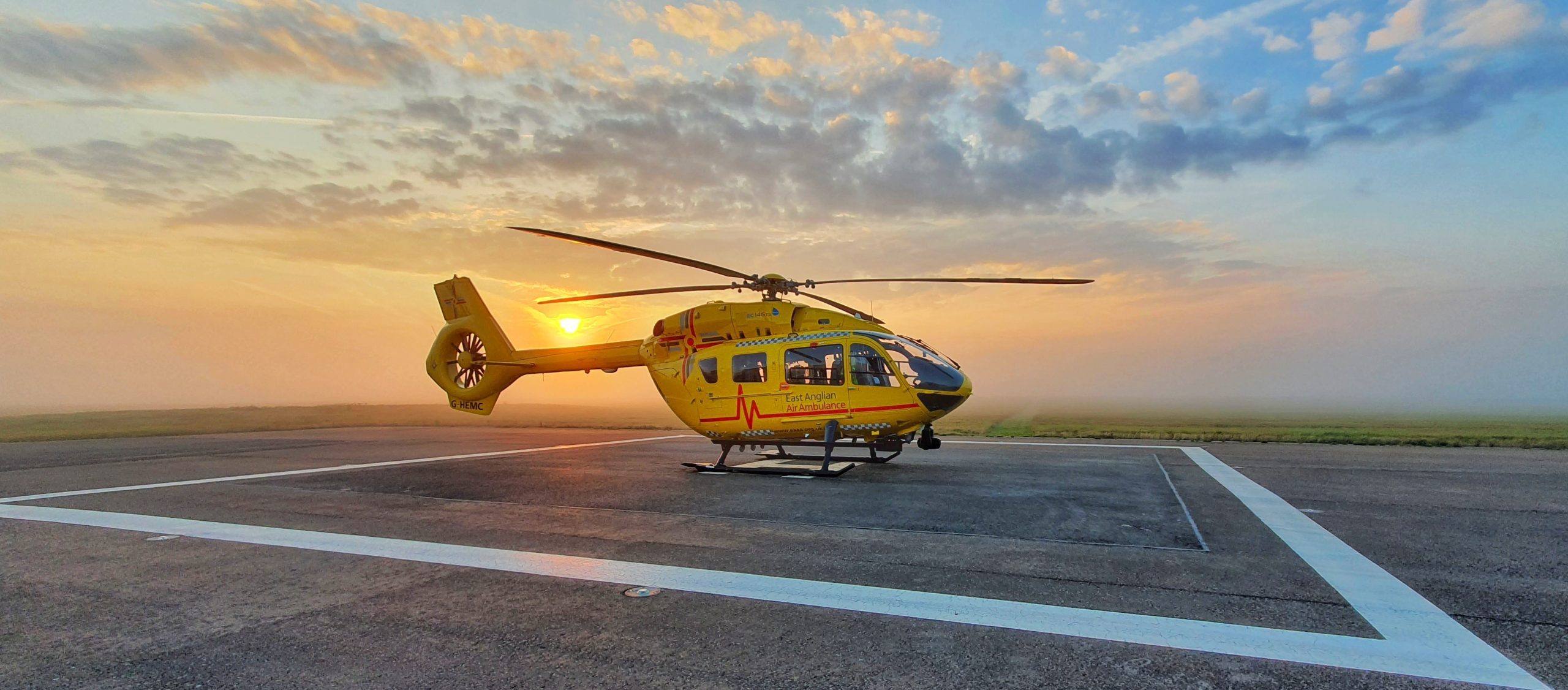 Helicopter at cambridge airport at sunset