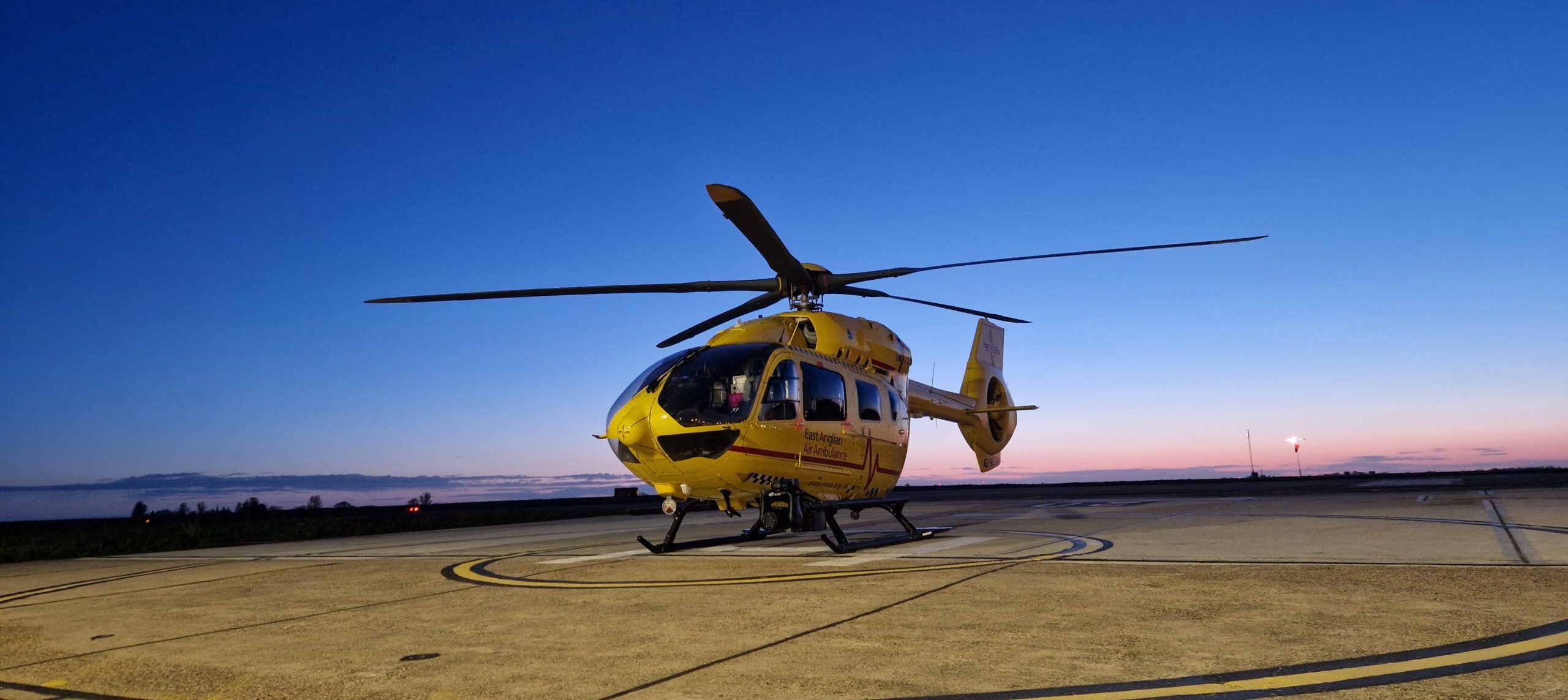 yellow helicopter on helipad