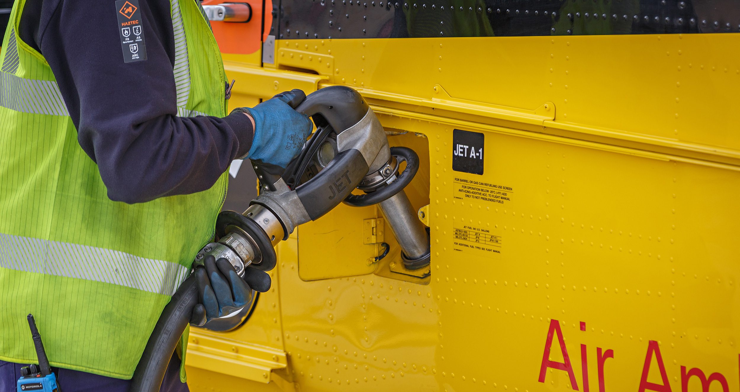 Yellow helicopter being refuelled at Norwich Airport