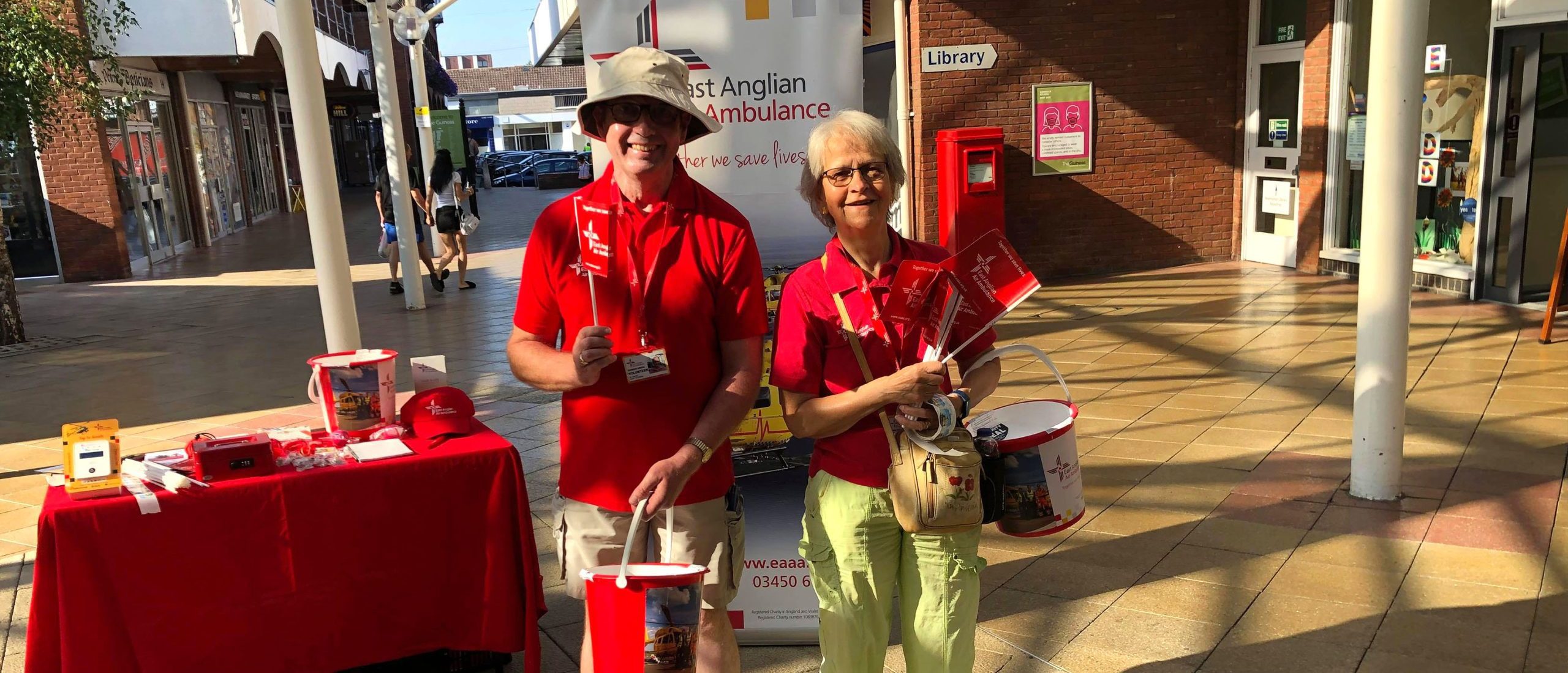 Two EAAA Volunteers standing on a high street with collection boxes