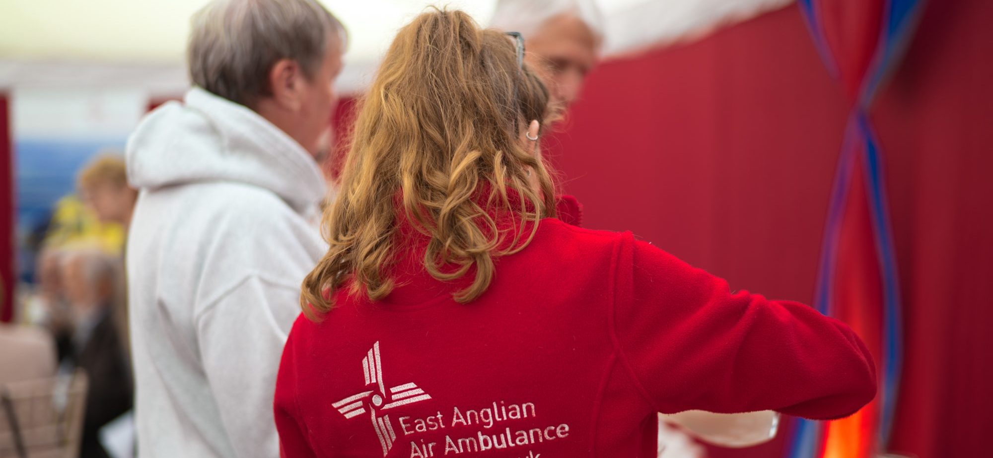 EAAA Volunteer from behind wearing red branded fleece