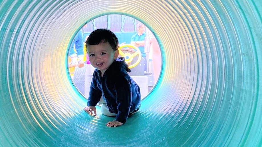 Baby Charlie playing and smiling, recovered from his incident.