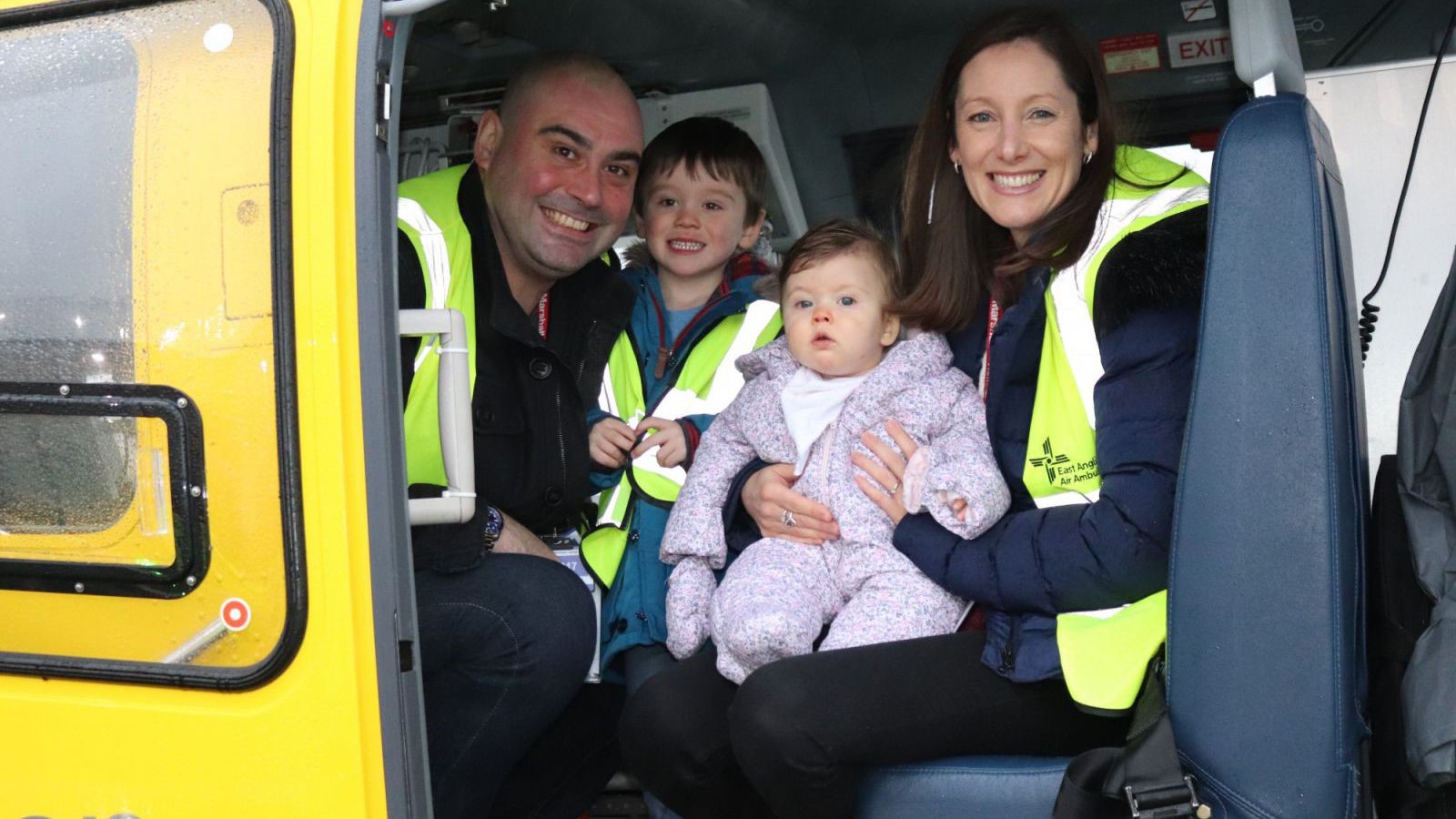 Emma Howard, Baby Willow and their family siting inside the EAAA helicopter.