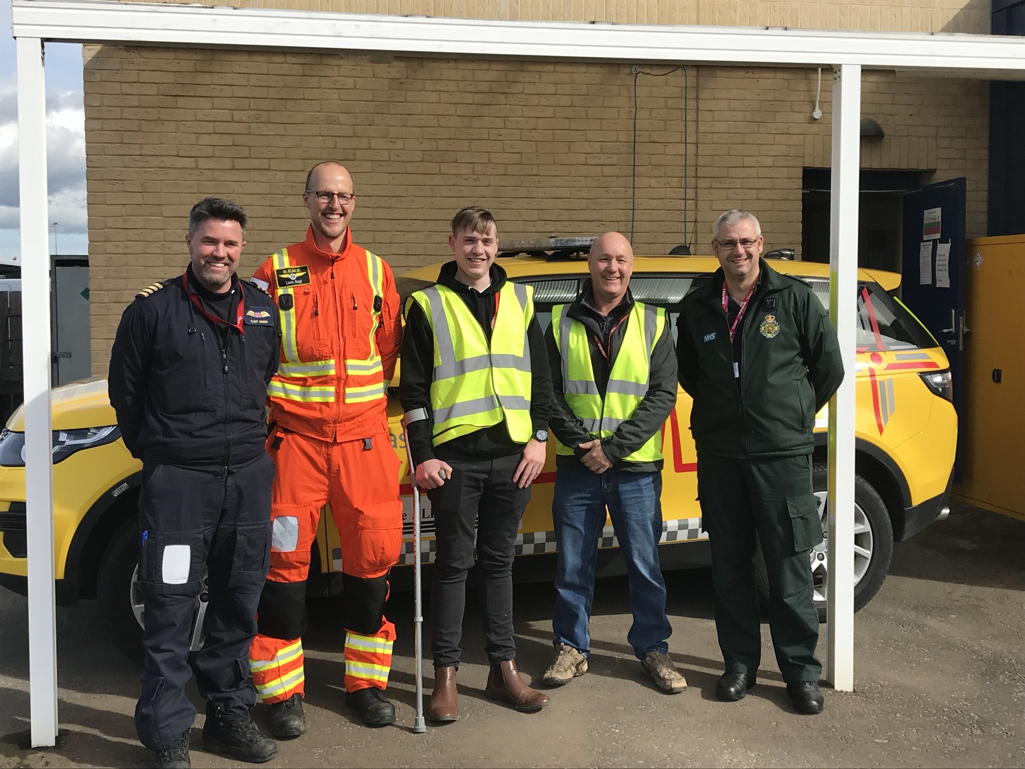 Jonathan Waddingham and colleague with the EAAA crew and EEAST paramedic standing in front of the Anglia Two RRV.