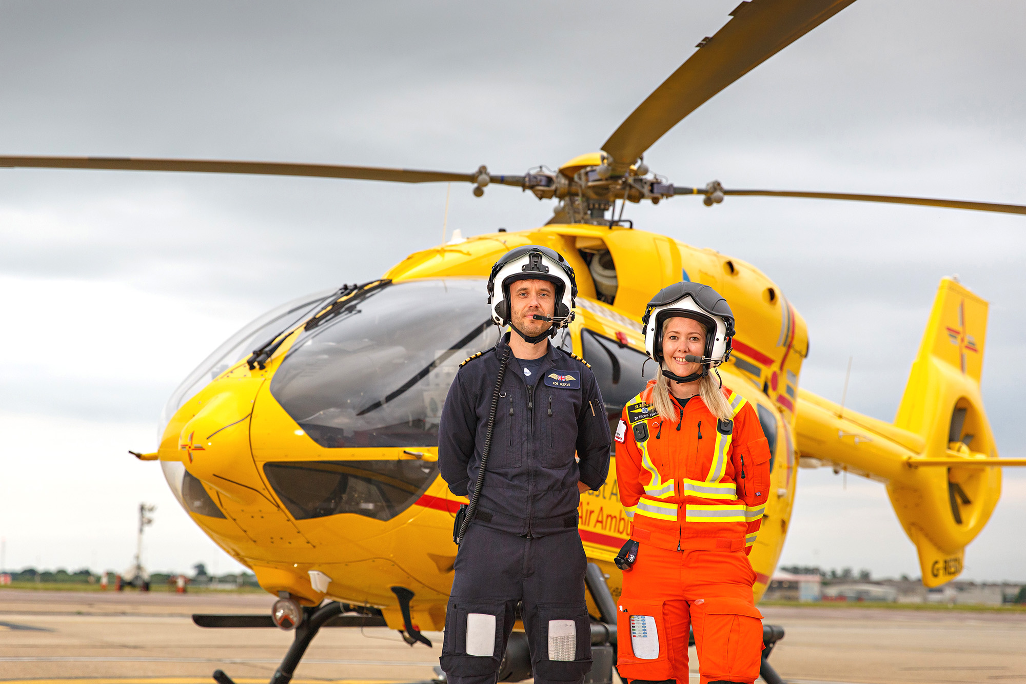 Doctor and paramedic with helicopter