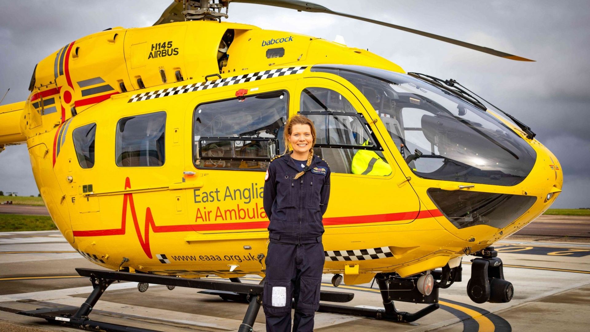 Captain Henrietta Davies Pilot in front of Anglia One Helicopter