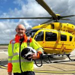 Pilot Steve Norris stood in front of EAAA helicopter