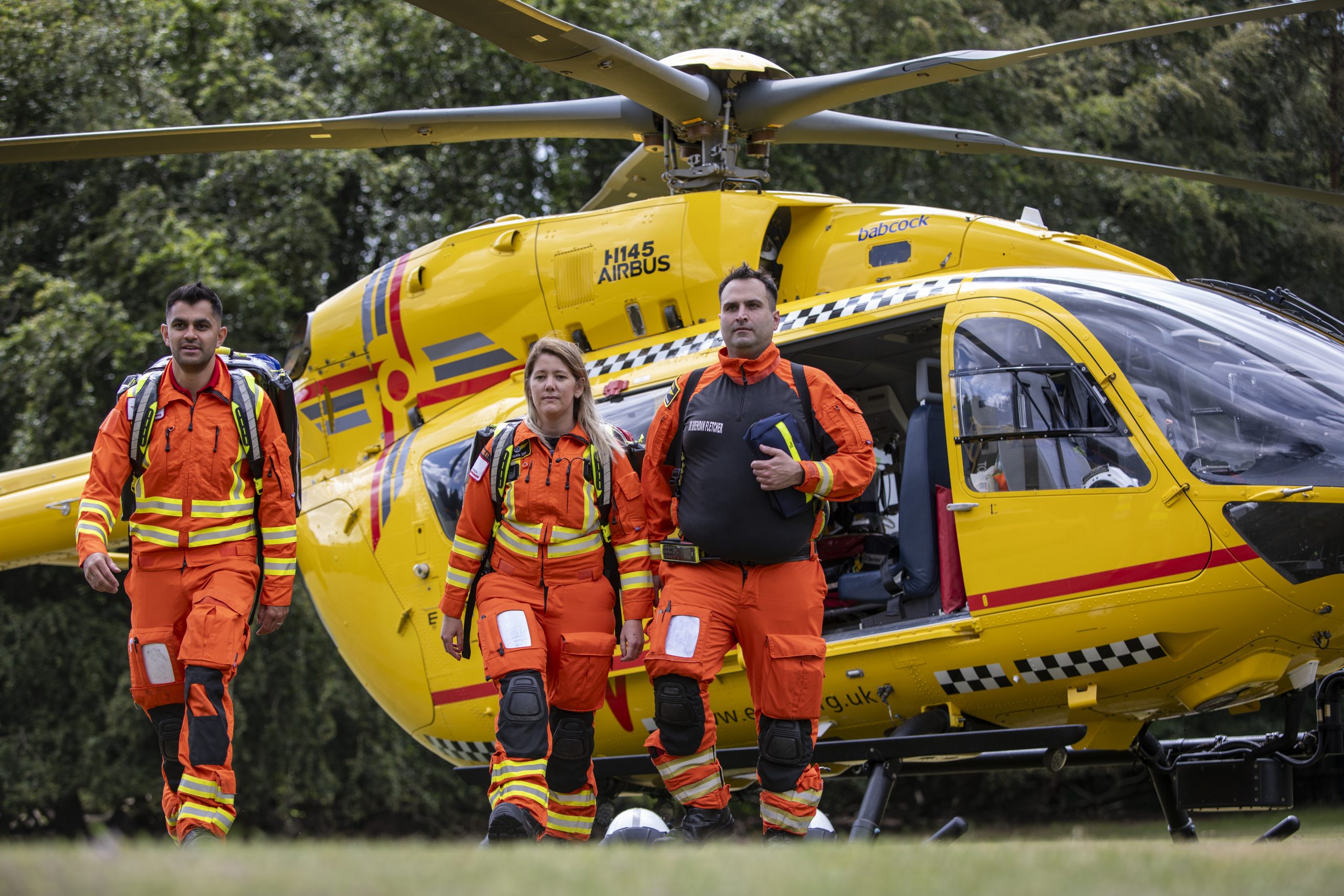 Doctor, critical care paramedic exiting helicopter at scene