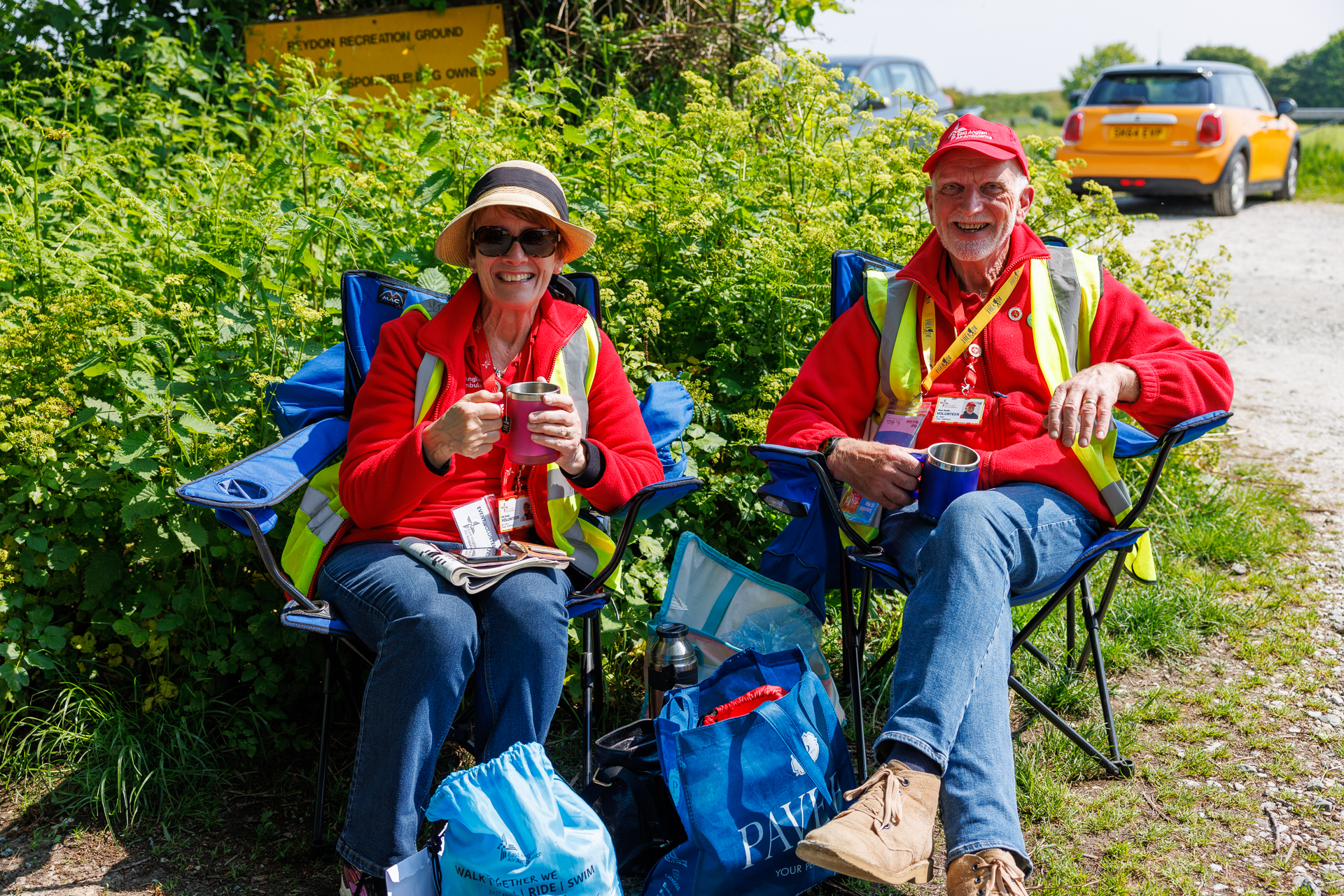 Gill and Alan, EAAA Volunteers, sitting in camp chairs at event