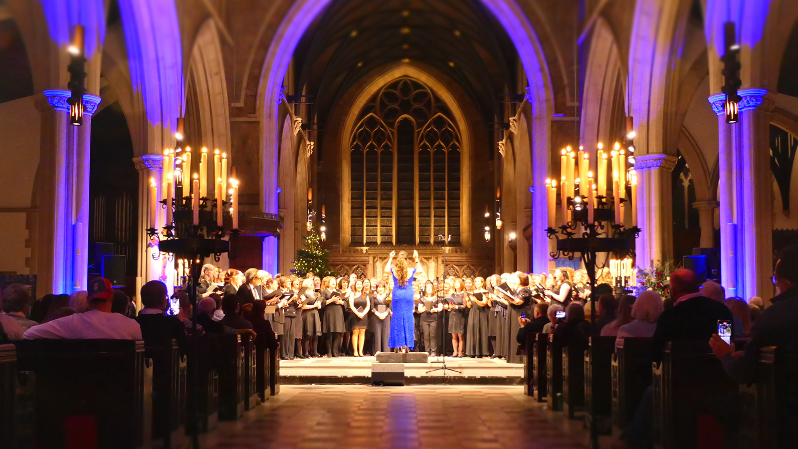 London Show Choir performing in a church at candlelight