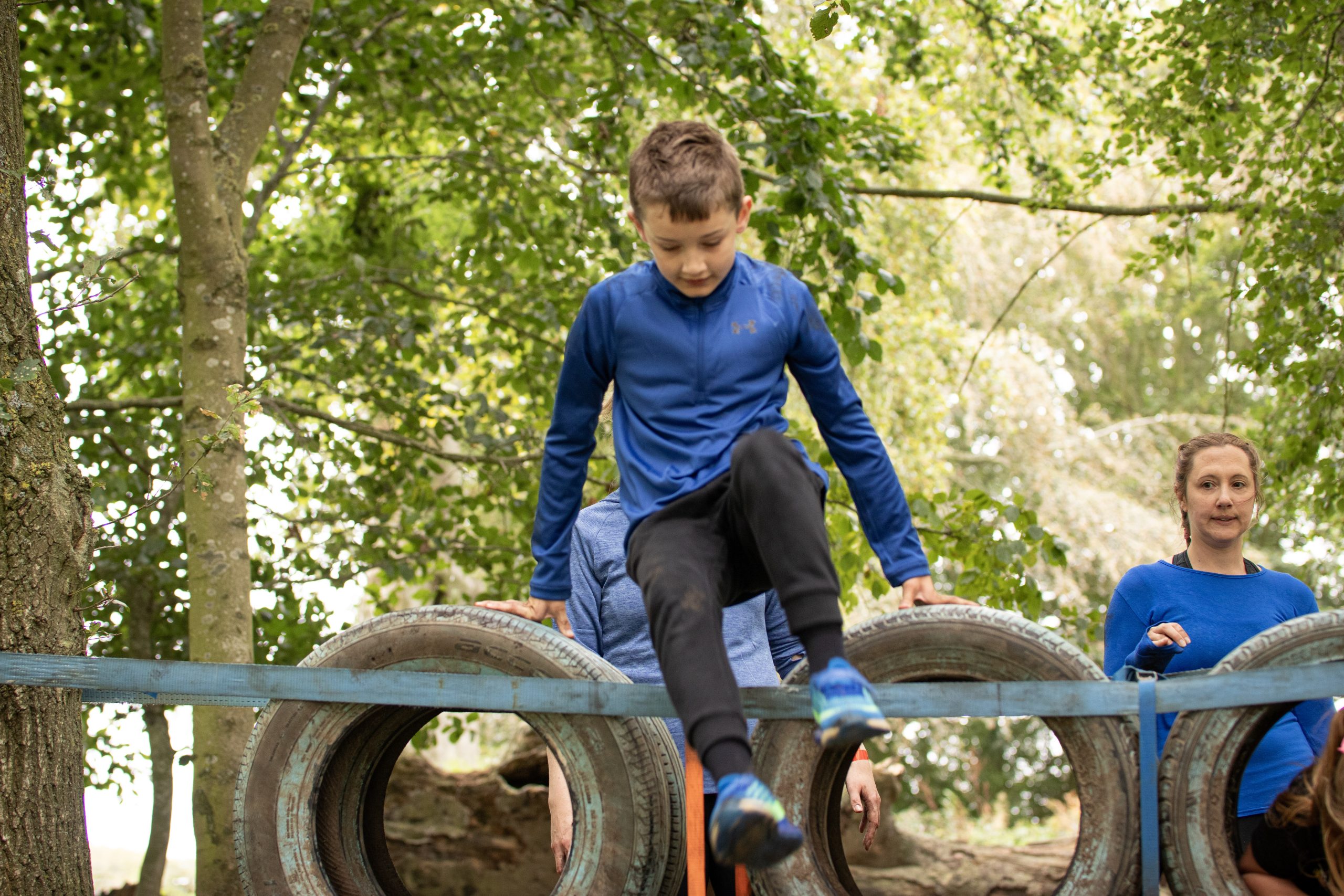 Mini Only The Brave Boy jumping over tires