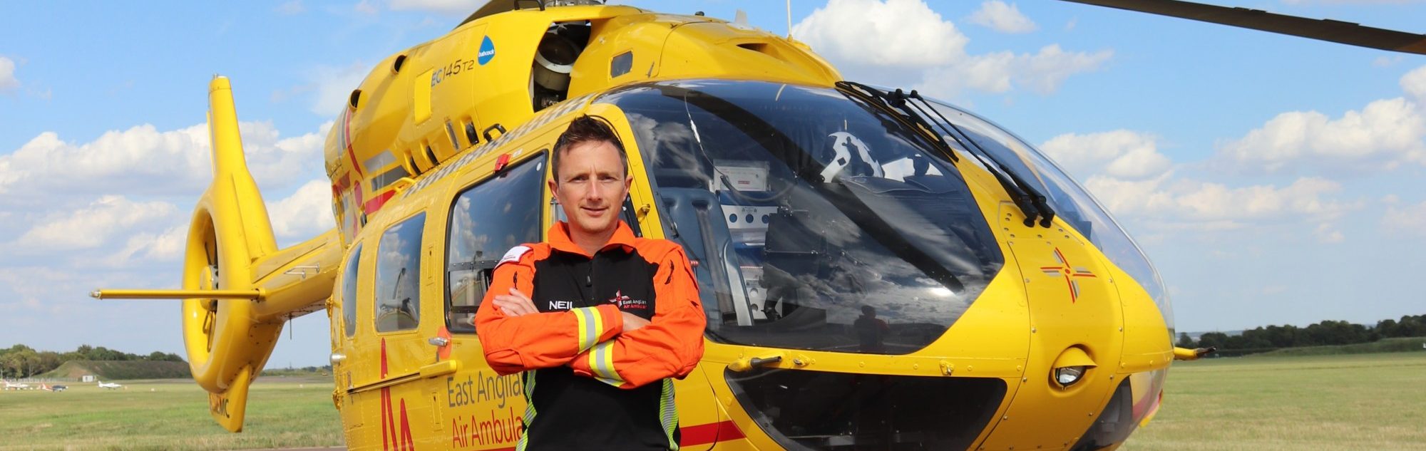 Doctor Neil Berry in front of helicopter