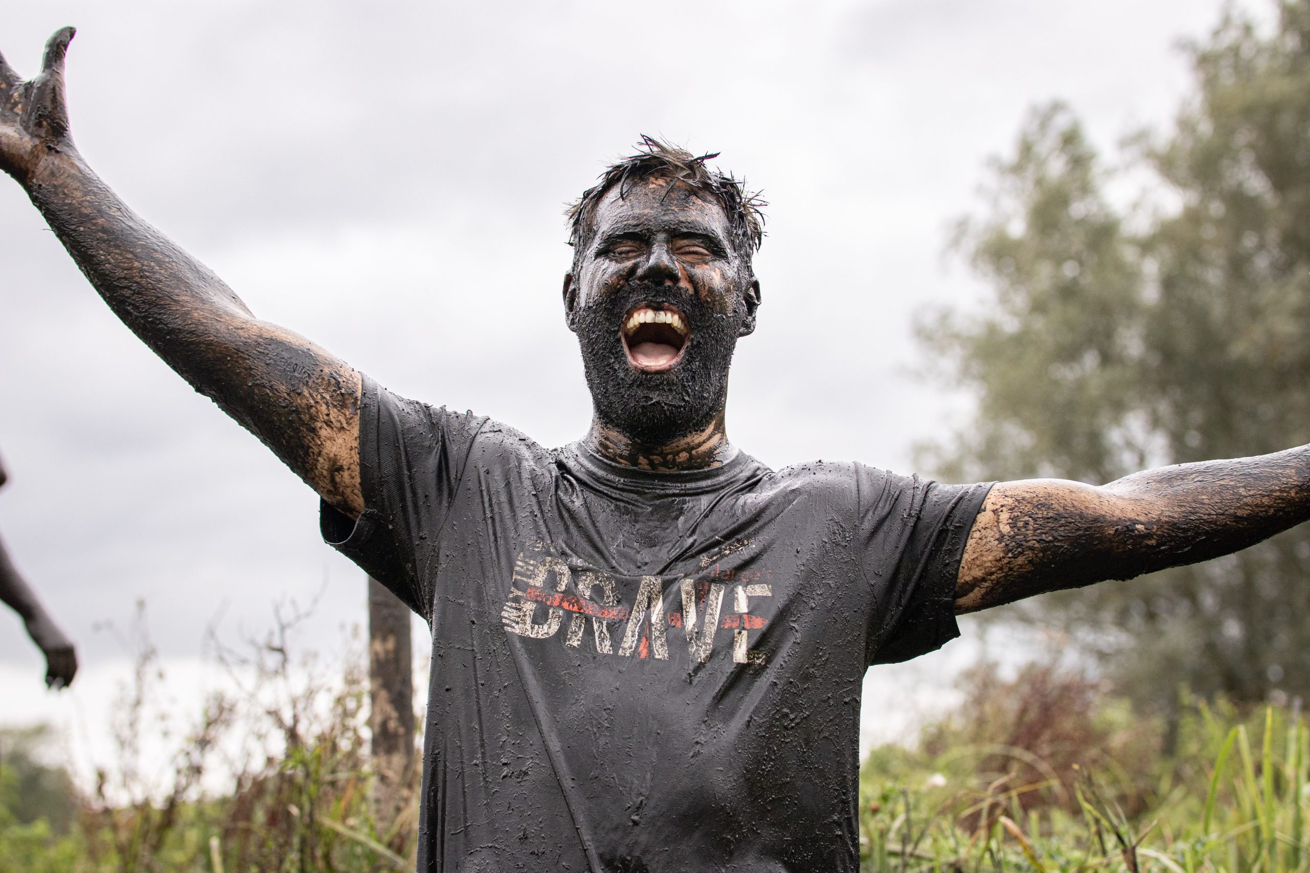 Only the Brave man covered in mud