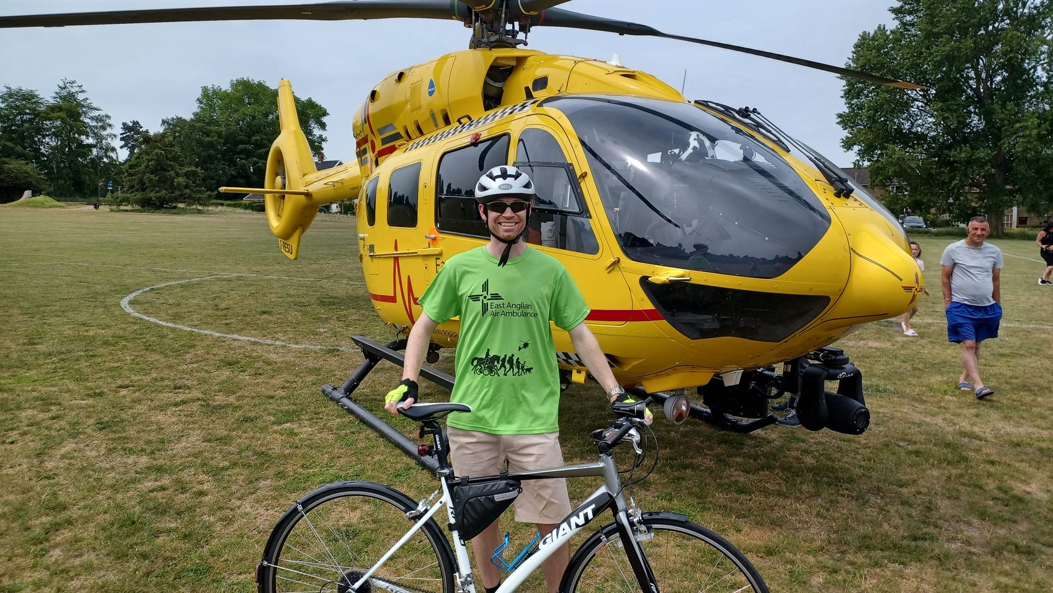 TWR Cyclist in front of helicopter