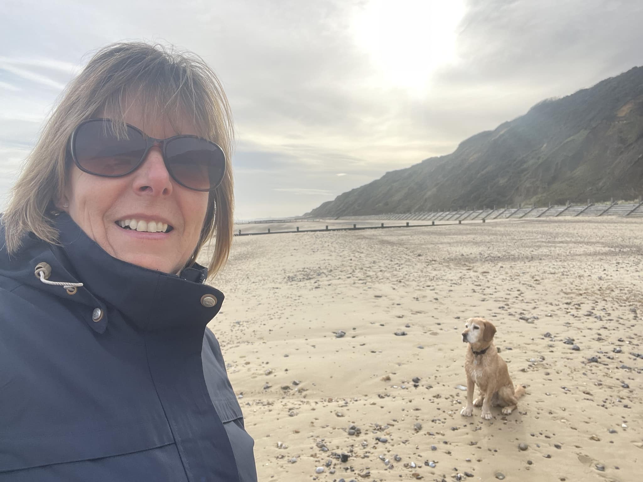 Together we step participant on a beach walk with dog