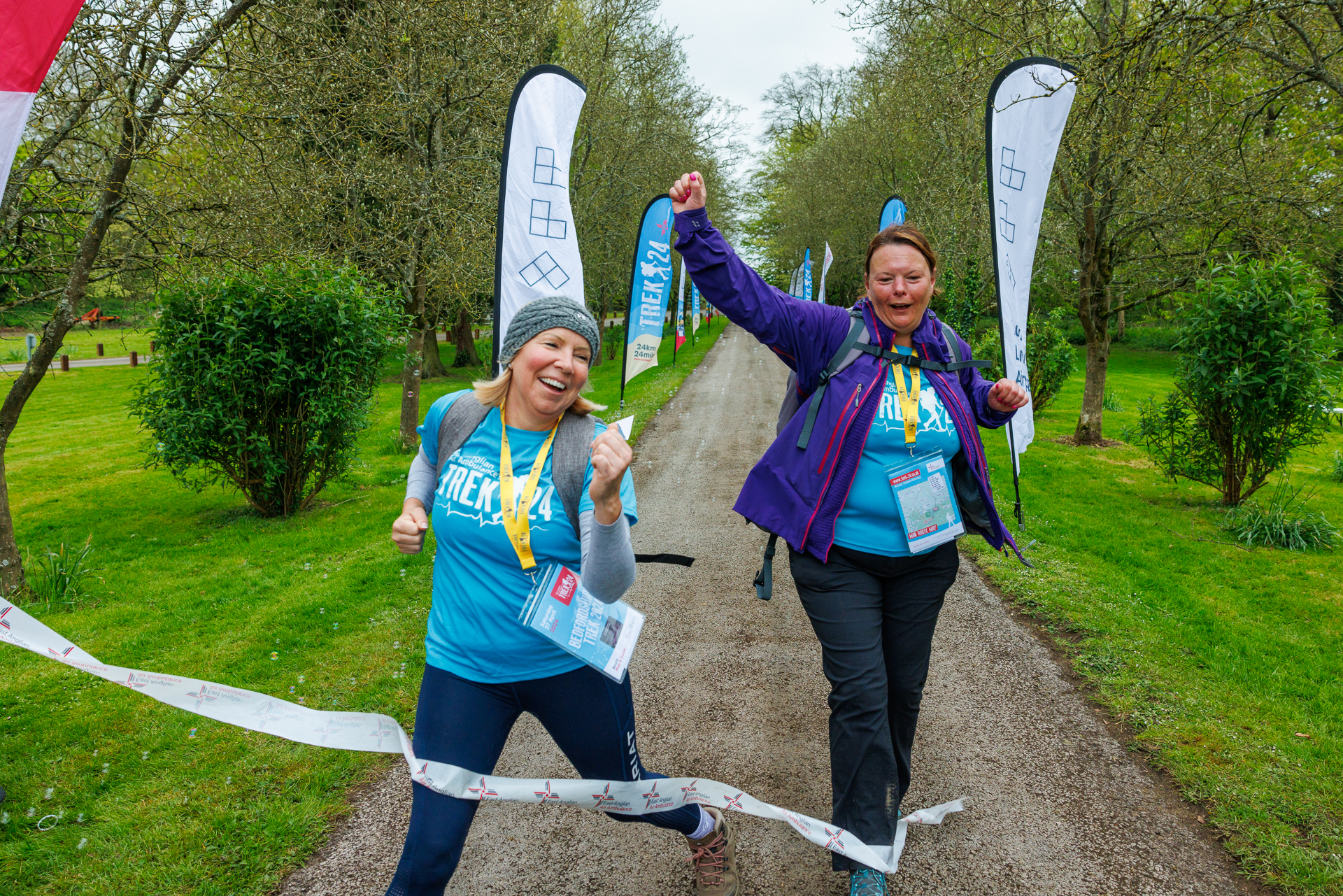 Trek Beds 24- two women jumping across the finish line