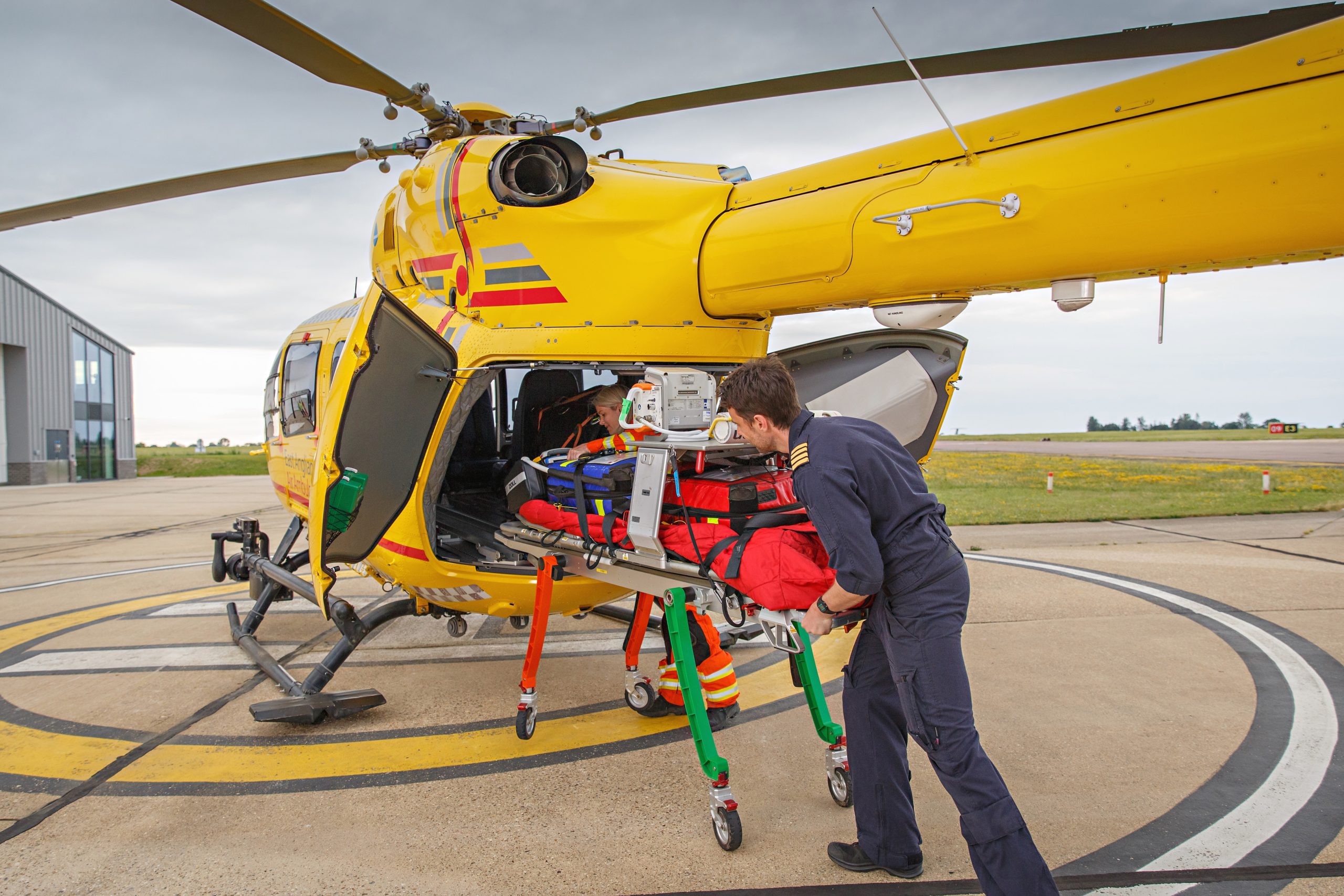 Pilot and doctor pushing trolley